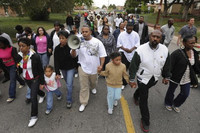 Terrance Roberts leads a march through the neighborhood after the Holly Shopping Center is burned down. Photo courtesy of "The Holly."