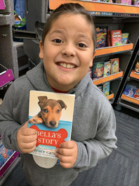  My son poses with "Bella's Story" by W. Bruce Cameron. Photo courtesy of Bonnie Jean Feldkamp. 