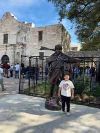 Ezra Cisneros poses with the statue of Davy Crockett. Photo courtesy of Bonnie Jean Feldkamp. 