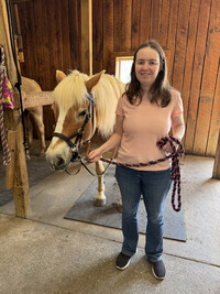  Sara Lamb poses with a horse at New Beginnings Therapeutic Riding Center where she volunteers. Photo credit: LifeWorks 