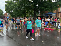  Elise Carter and Trinity Walsh walk in the Northern Kentucky Pride parade. Photo credit: Elise Carter. 