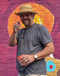  Tr&#233;s Taylor pauses while painting a mural. Photo Credit: Tr&#233;s Taylor 