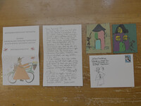 . Tr&#233;s Taylor's tar paper houses and love letters he sends to spread joy are spread out on a table. Photo Credit: Bonnie Jean Feldkamp 
