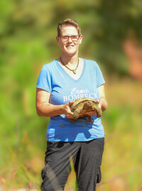 Bonnie Jean Feldkamp releases a rescued gopher tortoise at Nokuse Preserve in Florida. Photo Credit: Erica Feldkamp