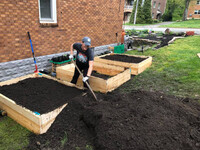  Bonnie Jean Feldkamp shovels dirt into a raised garden bed. Photo Credit: Bonnie Jean Feldkamp. 