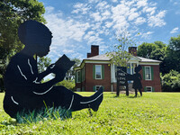 The "Childhood Interrupted" art installation depicts enslaved children reading and learning on the lawn of the Farmington plantation house, which would have been forbidden. Photo Credit: Bonnie Jean Feldkamp