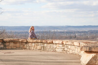 Scarlett Hendrix-Inman sits at the overlook in historic Olmsted-designed Iroquois Park in Louisville, Kentucky. Photo Credit: Olmsted Park Conservancy