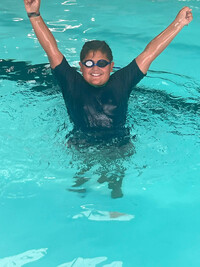  Ezra celebrates passing his swim test. Photo Credit: Louisville YMCA 