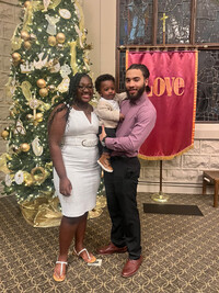 Armelle and Terrance Bradshaw pose with their infant son. Photo credit: Terrance Bradshaw.
