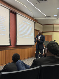 Ricky Jones speaks to a crowded auditorium about ant-DEI policy at the University of Louisville. Photo Credit: Bonnie Jean Feldkamp