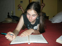 Katie O'Nell writes in the travel journal she kept during a European trip with her mother. Photo courtesy of Jennifer Coburn.