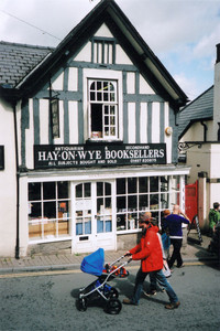 Visitors stroll by one of 24 bookshops in Hay-on-Wye, Wales. Photo courtesy of Sharon Whitley Larsen.