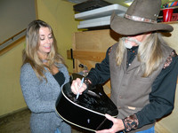  Country-western songwriter Dean Dillon signs a fan's guitar at the Songwriters Festival in Crested Butte, Colorado. Photo courtesy of Steve Bergsman. 