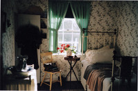 Anne's upstairs room has a single iron-and-brass bed and looks out over the brook, "Haunted Wood" and "Orchard Slope." Photo courtesy of Sharon Whitley Larsen.