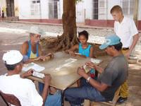  . A group of people enjoy an outdoor game of dominoes in Cuba. Photo courtesy of Victor Block. 