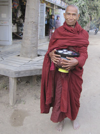  Early on a Myanmar morning a Buddhist monk starts for home with his daily collection of donated food. Photo courtesy of Barbara Selwitz. 