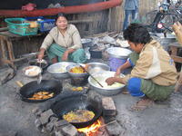  Food preparation is an integral part of an Ayeyarwady River town marketplace in Myanmar. Photo courtesy of Barbara Selwitz. 