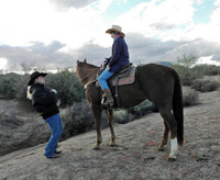  Elaine Pawlowski shows a student at Arizona Cowboy College in Scottsdale how to control a horse by using the reins properly. Photo courtesy of Victor Block. 