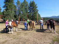  A family prepares for an afternoon of exploration in Montana's wilderness on horseback with expert guides from Seeley Lake's Rich Ranch. Photo courtesy of Lesley Sauls. 