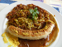 Sausage in onion gravy with rosti is a favorite at Restaurant Walliserkanne in Zermatt, Switzerland. Photo courtesy of John Blanchette.