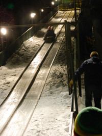 A pair of tobogganers makes a nighttime run in Lake Placid, New York. Photo courtesy of Steve Bergsman.