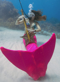  .A "mermaid" plays a sculpted clarinet at the Lower Keys Underwater Music Festival in Florida. Photo courtesy of Mary Ann Walker. 