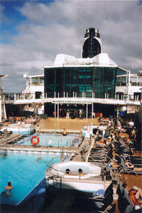 Passengers relax around the Celebrity Silhouette pool while listening to a band perform on the deck. Photo courtesy of Sharon Whitley Larsen.