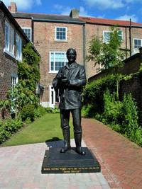  In 2015 the lifelike statue of James Alfred Wight &#8212; "James Herriot" &#8212; was erected in the garden of the World of James Herriot Museum in the town of Thirsk, England. Photo courtesy of Athena Lucero. 