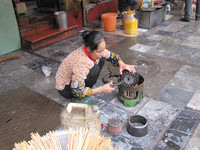  A woman in Hanoi, Vietnam, uses the sidewalk as a kitchen. Photo courtesy of Barbara Selwitz. 