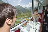 A couple enjoy a trip on the Glacier Express through the Swiss Alps. Photo courtesy of the Glacier Express.