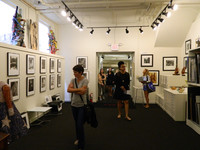  Visitors check out the art available in the loft space at The Arts Company. Photo courtesy of Steve Bergsman. 