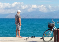 A lone fisherman tries his luck in Xylocastro, a seaside village on the northern coast of the Peloponnesian Peninsula in the Gulf of Corinth, Greece. Photo courtesy of Athena Lucero.