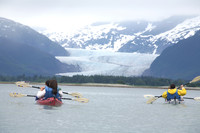 Visitors to Alaska kayak near the Mendenhall Glacier. Photo courtesy of Brian Adams, Alaska Travel Industry Association.