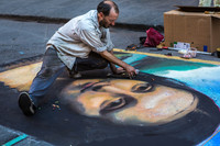 A street artist in Venice, Italy, draws the "Mona Lisa" in chalk on asphalt. Photo courtesy of Mihai Andritoiu/ dreamstime.com.