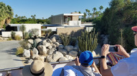 Participants in Palm Springs' Modernism Week photograph architect Richard Neutra's Kaufman House from a bus tour. Photo courtesy of Jim Farber.