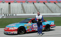 The author stands beside his car at the Richard Petty Driving Experience at the Texas Motor Speedway. Photo courtesy of Bill Neely.