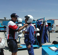 Crew members at the Richard Petty Driving Experience at the Texas Motor Speedway outfit the author with the proper clothing and safety equipment. Photo courtesy of Bill Neely.