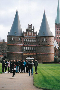 A group of tourists poses in front of the historic 540-year-old Holsten Gate, which welcomes visitors to the Old Town of Lubeck, Germany, a UNESCO World Heritage Site. Photo courtesy of Sharon Whitley Larsen.