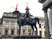 Citizens of Glasgow, Scotland, make a joke by placing traffic cones on the statue of the Duke of Wellington and his horse outside the Gallery of Modern Art. Photo courtesy of Candyce Stapen.