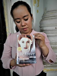  A guide named Ph-ung at "The Lover's House" in Sa Dec, Vietnam, displays a copy of the book that made the home famous. Photo courtesy of Steve Bergsman. 