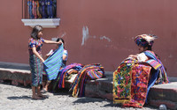 Guatemalan women sell brightly colored traditional tapestries to visitors on the streets of Antigua Guatemala. Photo courtesy of Barbara Selwitz.