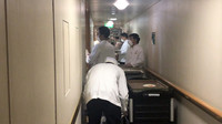 Crew members serve meals to quarantined passengers on the Diamond Princess. Photo courtesy of Philip Courter.