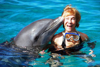 The author swims with Romeo the dolphin at the Dolphin Academy, Curacao Sea Aquarium. Photo courtesy of Victor Block.