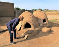  A visitor examines the "hornos" where Native Americans still bake bread in Taos, New Mexico. Photo courtesy of Victor Block. 