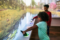 A visitor to the Planet Word Museum in Washington, D.C., is surprised when a storybook diorama appears magically on the wall. Photo courtesy of DuHon Photography.