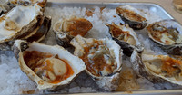  Fresh grilled oysters in bubbling chipotle butter are popular offerings on the menu at FINCA in Paso Robles, California. Photo courtesy of Jim Farber. 