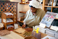  A shopkeeper in traditional attire shows visitors to Colonial Williamsburg, Virginia, how business was done in earlier days. Photo courtesy of Aviahuismanphotography/Dreamstime.com. 