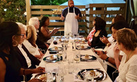  Chef Martin Draluck explains the significance of their meal to participants at a "Hemings & Hercules" dinner at Post and Beam in Los Angeles, California. Photo courtesy of Jim Farber. 