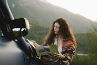  A traveler checks a brochure for hotel discounts during a road trip. Photo courtesy of Pexels.com. 