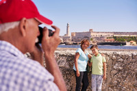 A grandfather takes a photo of his wife and grandson in Havana, Cuba. Photo courtesy of Road Scholar.
